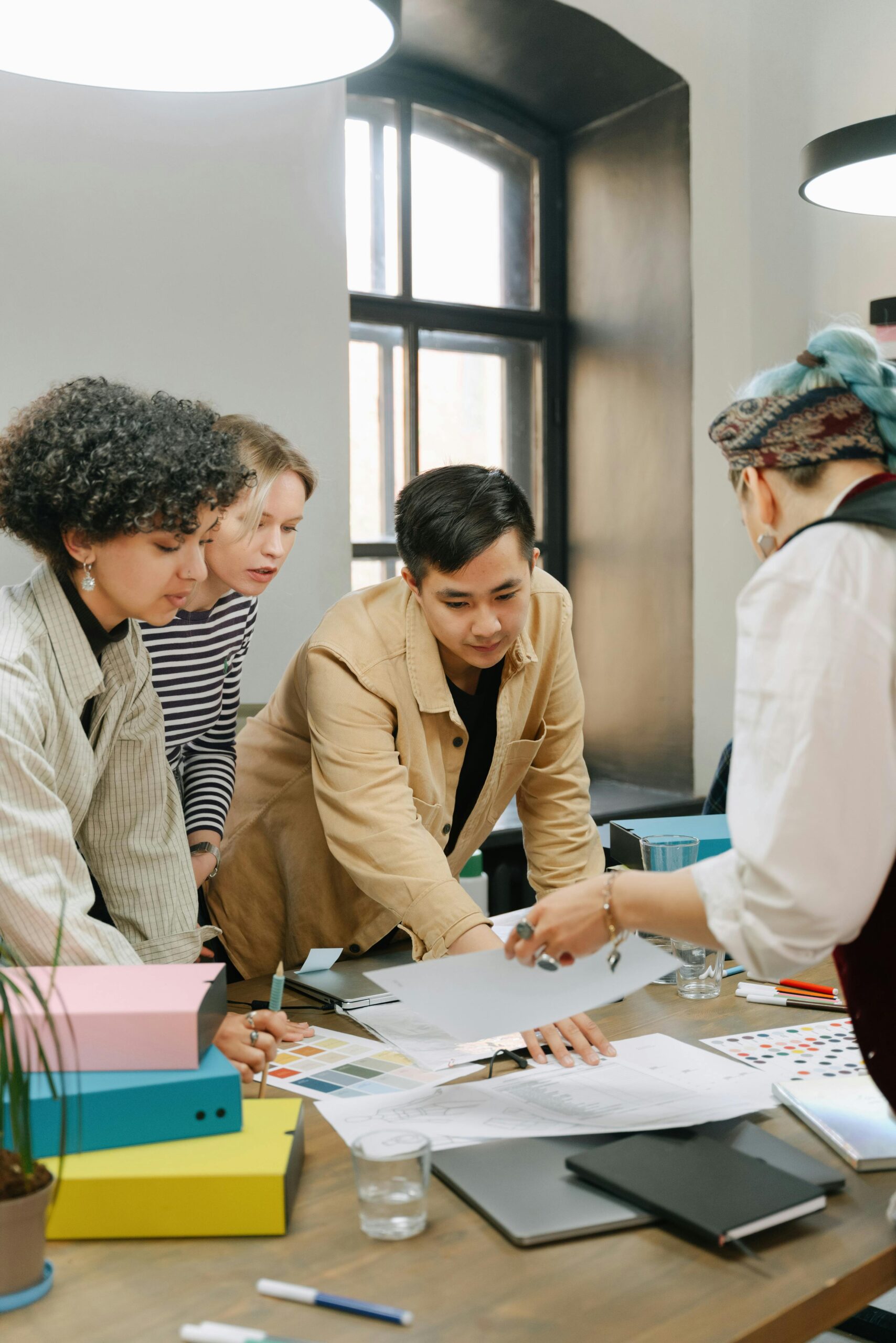 A diverse team engaged in a collaborative meeting in a modern office setting.